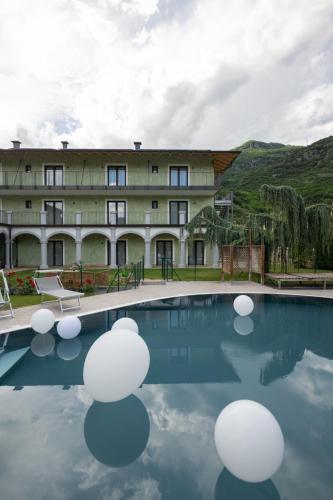a large building with a pool in front of it at Residence Al Frantoio in Arco