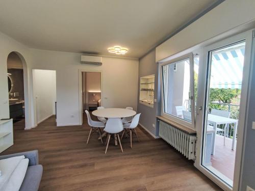a living room with a table and chairs and a window at Apartment Garda Sapphire by Interhome in Riva del Garda
