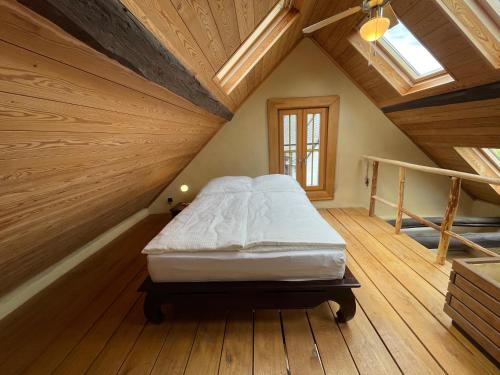 a bedroom with a large bed in a attic at Ferienhaus Romantica in Bruttig-Fankel für 2 Personen in Bruttig-Fankel