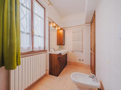 a bathroom with a sink and a toilet and a window at Holiday Home Villa Giuliana by Interhome in Querceta