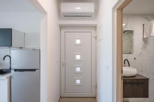 a white door in a kitchen with a sink at Apartments dida Ante in Blato