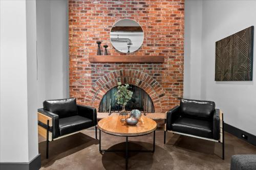 a living room with two chairs and a brick fireplace at Ambassador Ridge w/Optional Boat Rental in Sherrills Ford