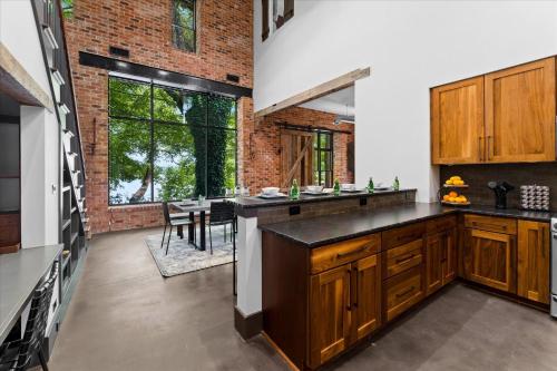 a kitchen with wooden cabinets and a brick wall at Ambassador Ridge w/Optional Boat Rental in Sherrills Ford