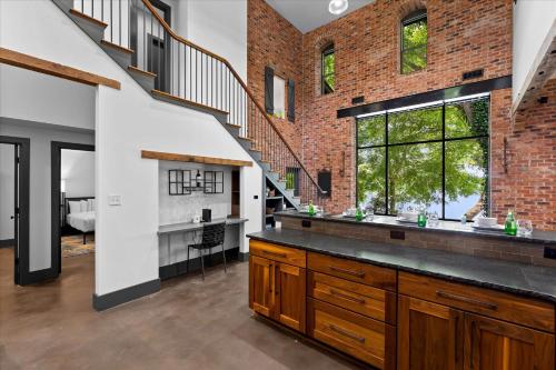 a kitchen with a brick wall and a staircase at Ambassador Ridge w/Optional Boat Rental in Sherrills Ford