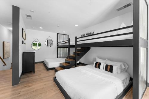 a bedroom with two bunk beds and a staircase at Ambassador Ridge w/Optional Boat Rental in Sherrills Ford