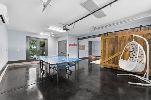 a room with a ping pong table and a swing at Ambassador Ridge w/Optional Boat Rental in Sherrills Ford