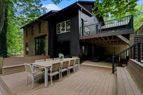 a house with a deck with a table and chairs at Ambassador Ridge w/Optional Boat Rental in Sherrills Ford