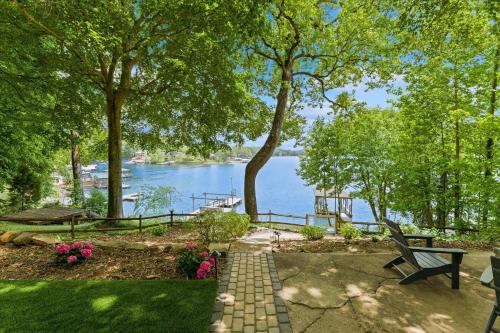 a bench sitting on a path next to a lake at Ambassador Ridge w/Optional Boat Rental in Sherrills Ford