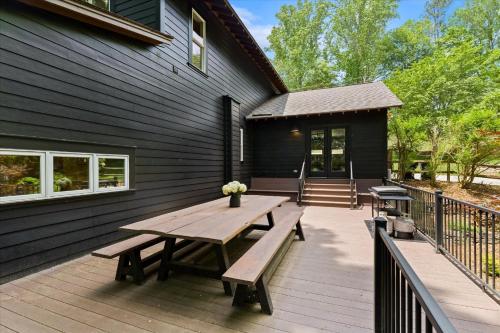 a wooden deck with a picnic table on a house at Ambassador Ridge w/Optional Boat Rental in Sherrills Ford