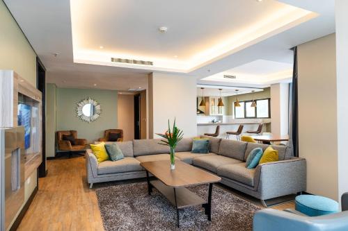 a living room with a couch and a table at Trademark Suites at Enaki Town in Nairobi