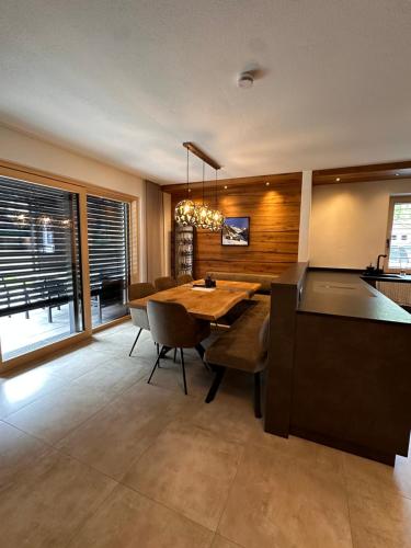 a dining room with a wooden table and chairs at Chalet Waldele in Sölden