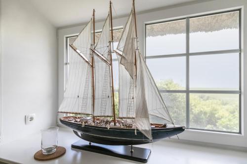 a model ship on a table next to a window at Austernfischer Haus in Pellworm