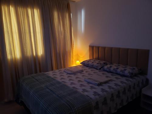 a bedroom with a bed with a nightstand and a bed sidx sidx sidx sidx at Pousada Monte Gerizim in Sao Paulo
