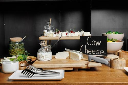 a counter with a cheese board with a sign on it at Castel Mimi Wine Resort in Bulboaca