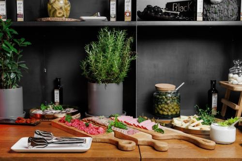 a table topped with appetizers and food on a shelf at Castel Mimi Wine Resort in Bulboaca
