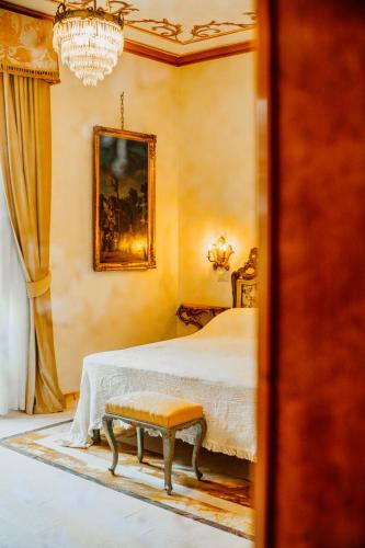 a bedroom with a bed with a bench in it at La Casa Di Agartha in Bolsena