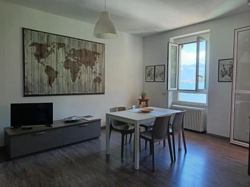 a living room with a table and chairs and a map on the wall at Casa Luisa in Bellano