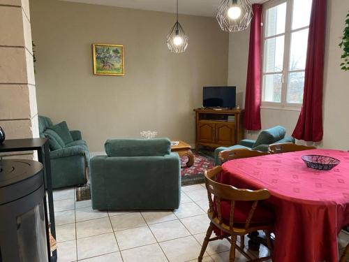 a living room with a pink table and chairs at Gite du parc du château de la Bouchatte in Chazemais
