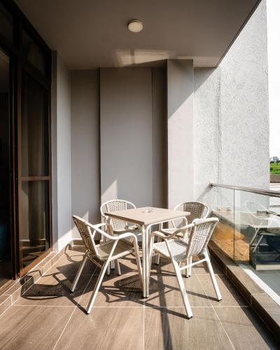 a table and chairs on the balcony of a building at Trademark Suites at Enaki Town in Nairobi