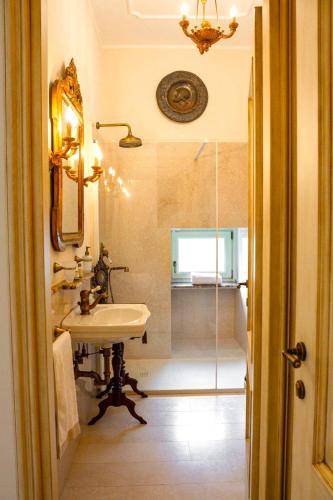 a bathroom with a shower and a sink and a mirror at La Casa Di Agartha in Bolsena