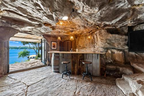 a bar in a cave with a rock wall at Nancy Key w/Pool, Wine Cave, Optional Boat Rental in Denver