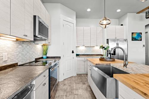 a kitchen with white cabinets and a sink at Nancy Key w/Pool, Wine Cave, Optional Boat Rental in Denver