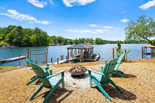 two green chairs and a playground next to a lake at Nancy Key w/Pool, Wine Cave, Optional Boat Rental in Denver