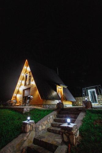 a house with lights on the side of it at night at Villa Route Rugove in Peje