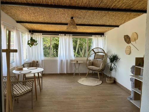 un salon avec une table, des chaises et des fenêtres dans l'établissement Studio 2, à Avignon