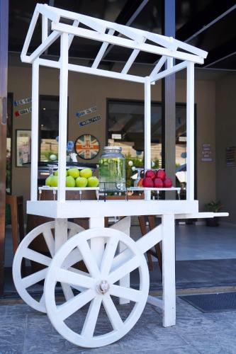 a white cart with fruits and vegetables on display at Aitch Boutique Hotel - an LIH Hotel in Madaba