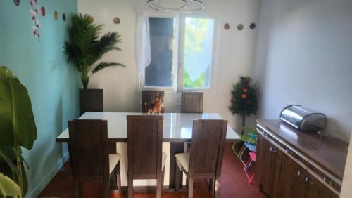 ein Esszimmer mit Tisch und Stühlen und einem Fenster in der Unterkunft Sogo in Villeneuve-sur-Lot