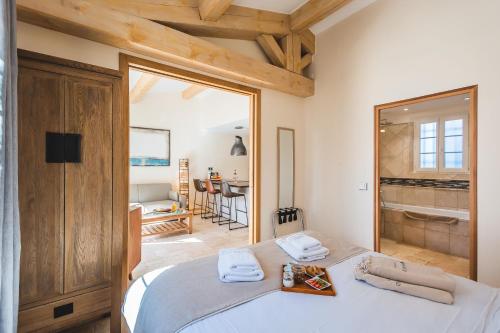 a bedroom with a bed with a large mirror at Les Maisons Du Sud in Saint-Tropez