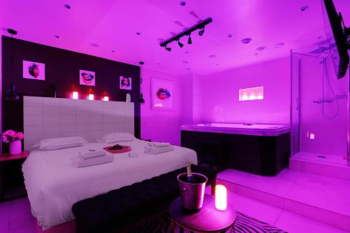 Cette chambre rose comprend un lit et une baignoire. dans l'établissement Intimate Apartment with Air Conditioner & Jacuzzi 2BR 6P Montmartre, à Paris