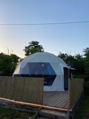 a large tent sitting on a wooden deck at Evaland Glamping Resort in Kuvançari