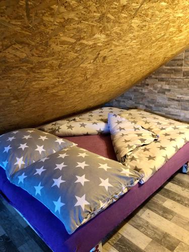 a bed with stars on it in a room at Apartmán Holany in Holany