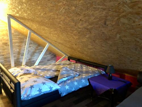 a bedroom with a bed in a attic at Apartmán Holany in Holany