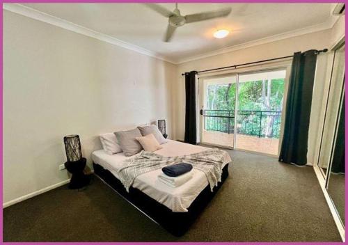 a bedroom with a bed and a large window at Riverside Boulevard 13-151 close to HOSPITAL in Ross River