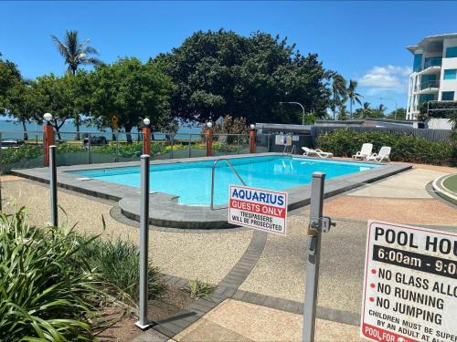 a swimming pool with a no swimming sign next to it at Aquarius 703 in Townsville