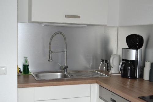 a kitchen sink with a faucet on top of it at Ferienwohnung Hampton in Braunlage