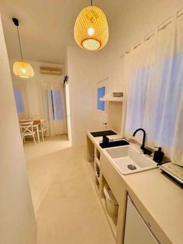 a kitchen with a sink and a counter top at Walk The View Apartment with village view in Chora in Ios Chora