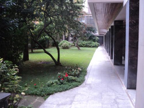 une passerelle vide dans un parc planté d'arbres et d'herbe dans l'établissement Studette meublée, Ranelagh Paris 16e, à Paris