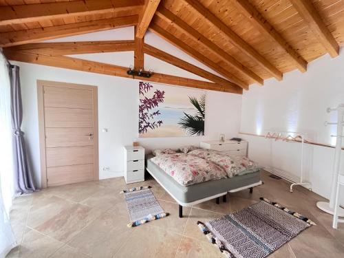 a bedroom with a bed and a wooden ceiling at Pilgrims Rest - Vila Nova de Cerveira - Hostel - Albergue - AL in Vila Nova de Cerveira