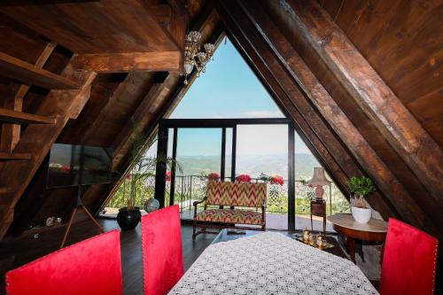 a room with a table and chairs and a large window at Sunrise House - Swimming Pool in Berat