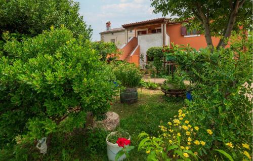 Un jardín con árboles y flores frente a una casa. en Beautiful Apartment In Sisan With Wifi, en Šišan