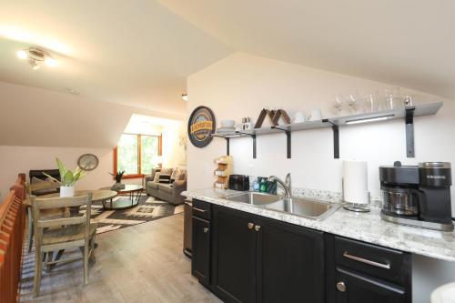 a kitchen with a sink and a living room at Cozy Mountain Retreat * Dog Friendly in Lyndhurst