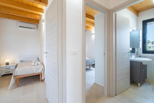 a bedroom with a bed and a bathroom at Agrivillage San Lorenzo in San Lorenzo
