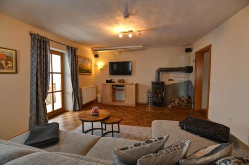 a living room with a couch and a table at Dienberger Ferienhaus in Untergriesbach