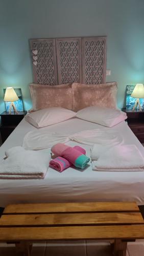a bed with two pillows and two towels on it at IthakiHouse II in Vathi, Ithaka