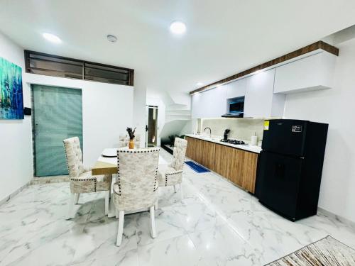 a kitchen and dining room with a table and chairs at La Roca 202 in Cali