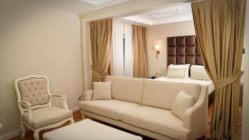 a living room with a couch and a bed at Gaia Suites Istanbul in Istanbul